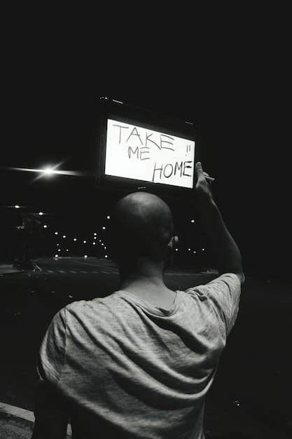 Close-up shot of a film critic reviewing notes during a movie screening at a film festival, with a laptop displaying a review website open in the background.