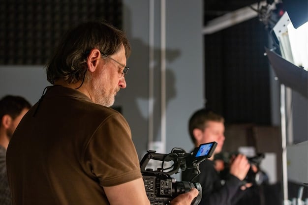 A behind-the-scenes photograph of the director in deep discussion with the cinematographer on set. The image captures the collaborative spirit of filmmaking.