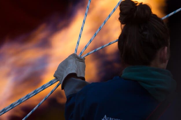 A close-up of a stunt coordinator examining safety rigging on a harness, highlighting the meticulous attention to detail required for stunt preparation.